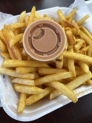 French Fries seasoned with salt and maybe paprika with their house secret sauce.