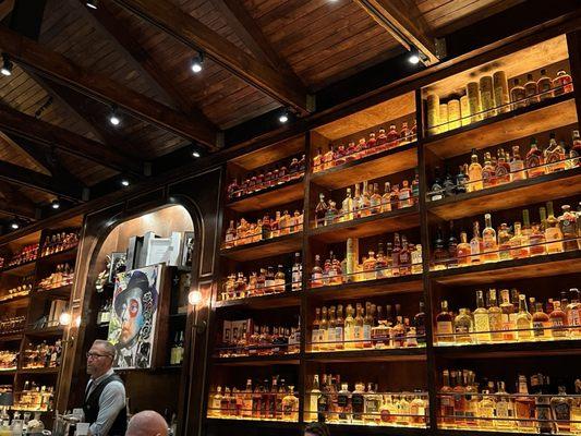 One of four walls filled with whiskey and rum to choose from