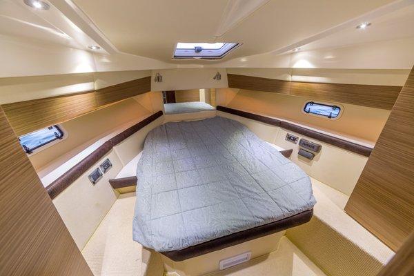 Private Stateroom with bed, skylight, sound system, storage.