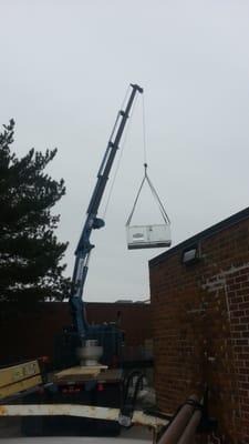 Installing a new Rooftop unit with our crane at a manufacturer in Wausau, WI.