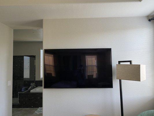 Perfectly mounted tv in our master bedroom.