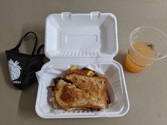 Cheese sandwich with lavender honey, bacon, and egg and mango, guava, and lemon fruit spritzer