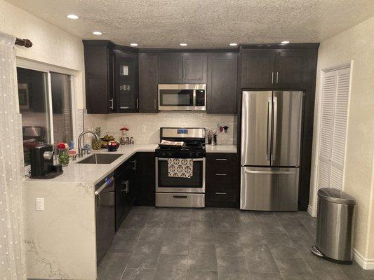 Finished kitchen with quartz countertops and black cabinets.  Everything is beautiful!