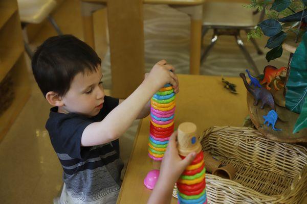 young boy stacks colorful blacks at MC-CDC