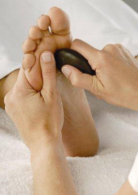 More stone over foot acupressure relief.