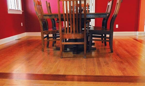 View of the White Oak floor with Brazilian Cherry border and stained cherry (color) and finished with satin water base finish.