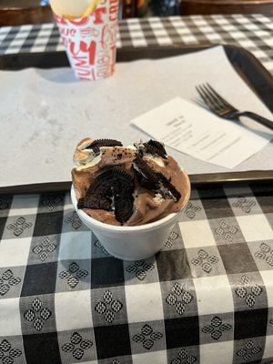 Swirl soft serve with crushed Oreos on top.