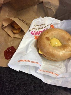 Bacon and egg bagel with hash browns.