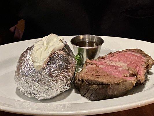 Prime rib au jus with a big, fluffy Idaho Baked Potato with butter and sour cream