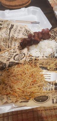 Was so hungry I forgot to take a picture right after opening the box.  Pork BBQ skewer (half eaten ) with rice and pancit.