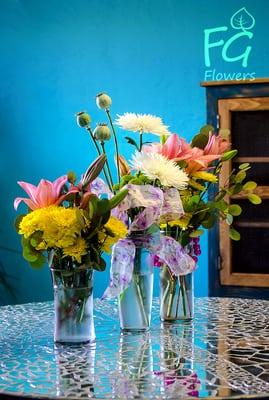 A trio of floral arrangements.