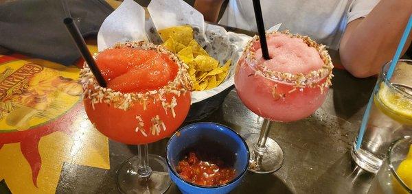 Strawberry margarita and prickly pear margarita and chips and salsa