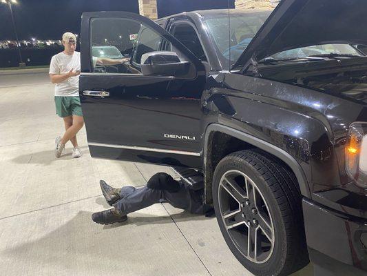 Mechanic helping us while stranded at gas station.