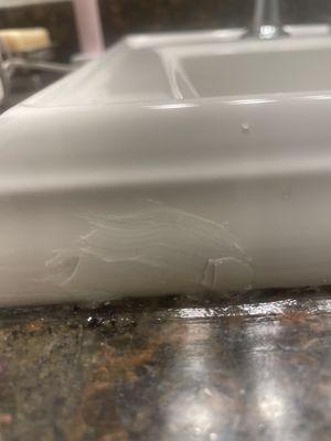 Damaged sink. Glue holding cracked out pieces of the sink