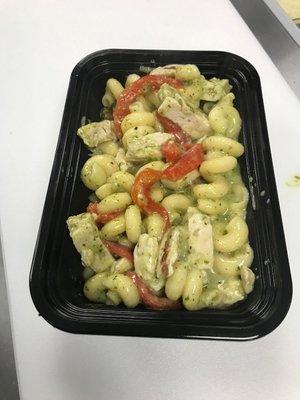 Custom mac and cheese bowl with chicken, roasted red peppers, and pesto topped with optional chipotle breadcrumbs.