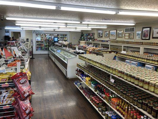 Meat counter on the left, frozen items (with bread on racks up top) center left. Note sign of where to queue up for the meat counter.