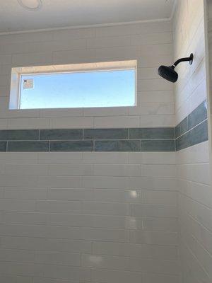 Subway with blue accent installed in master bathroom.