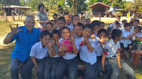 Jeff Milam and family at Laos mission trip. Jeff was touched by kids at a village and blessed the soccer team with shoes, socks, & uniforms.