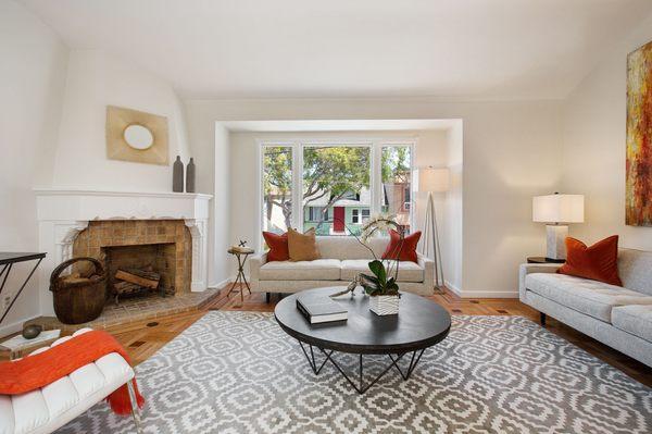 Living room of a recent listing. Refinished hardwood floor, paint and staging.