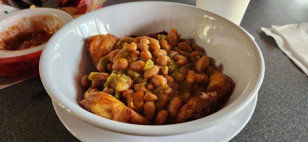 Chile relleno pair topped by whole beans.