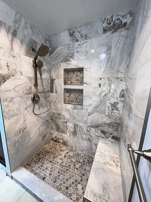 Removed the Tub from this bathroom and converted it into a beautiful walk in Shower with 2 nichos & a bench.