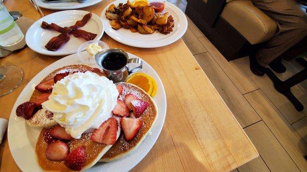 Gluten free pancakes with strawberries and whipped cream ( non dairy whipped cream is available) bacon and breakfast potatoes