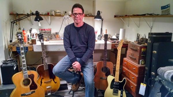 Me in the shop with some of my own guitars.