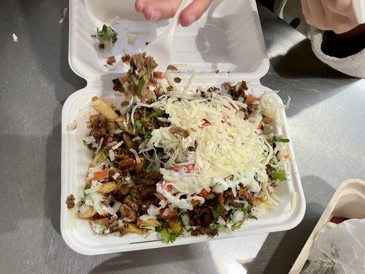 Loaded Asada fries, partially eaten