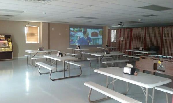 Our party room with seating for 72, free foosball and pool table, air hockey, 6 foot by 9 foot high def protection TV.