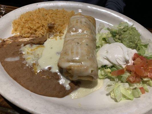 Shrimp chimichanga topped with queso