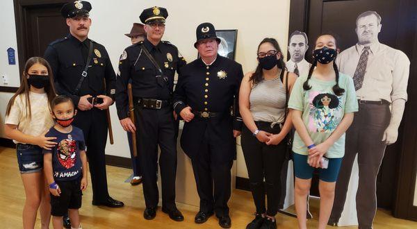 Photo op with a few officers wearing LAPD uniforms from various periods in time