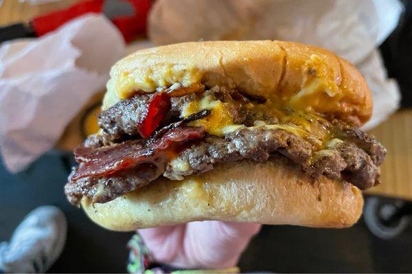 Double smash burger with vegan cheese and bacon