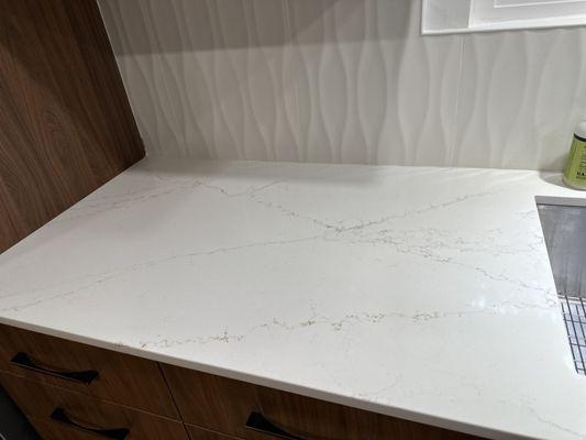 Close up of kitchen countertop showing gold and gray marbling