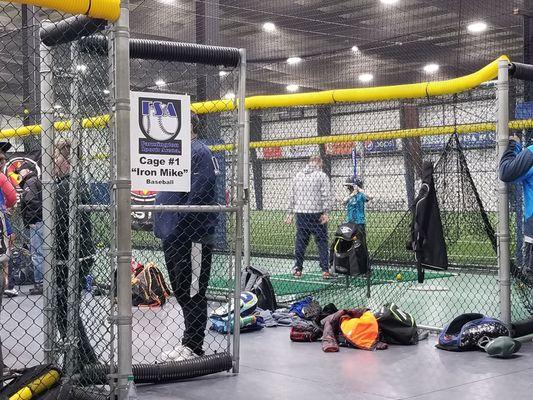 Batting cages with auto pitching machines