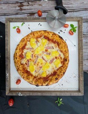 Hawaiian pizza with fresh cut pineapples