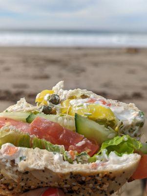 Veggie bagel sandwich on an everything bagel with veggie cream cheese