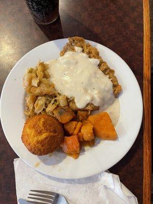 Chicken fried steak with cabbage, yams and a cornbread roll