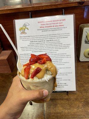 Banana whip, coconut flakes, granola, peanut butter sauce, and strawberries