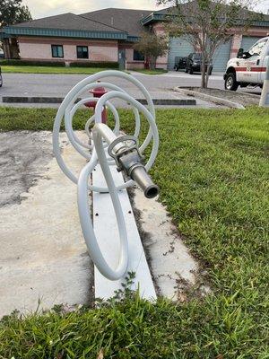 Fire hose sculpture that's actually a Bike rack - creative!