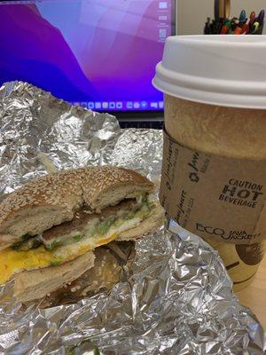 Sausage, Egg, Cheese, Avocado on a sesame bagel. Large black coffee.