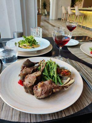 Grilled lamb chops with a side of green beans. Also ordered the parmesan squash.