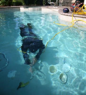 Diver in pool detecting leak