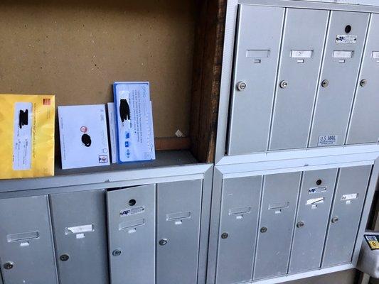 Mailbox unit with no cover for four mailboxes and doors ajar/unlocked on several others. Followed up on issue on Jan 7.