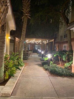 Promenade between front desk/lobby building and hotel by itself.