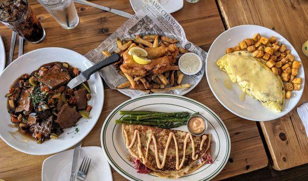 Pot roast, fish and chips, Reuben boxty, and mushroom omelet with cheese and side of breakfast potatoes