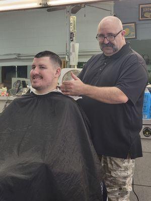 My son is getting a haircut  by Tony.