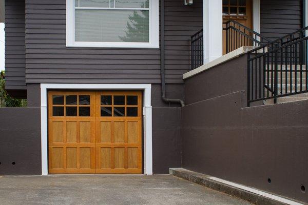 One of our hand built Portland Carriage Collection custom wood doors - shown in the Piedmont 12-lite design, configured with no windows.