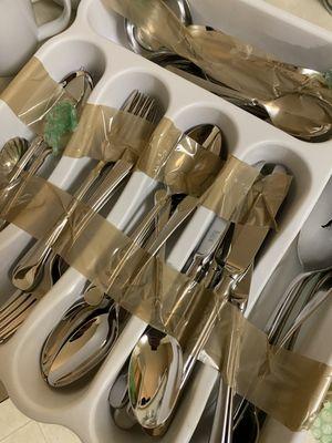 Brown packing tape directly wrapped around kitchenware, plates, silverware, etc.