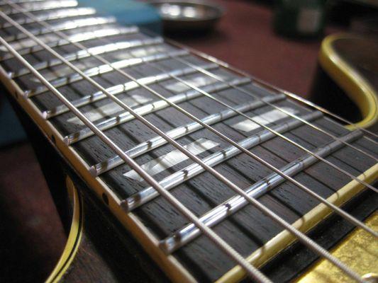 Newly installed stainless steel frets, leveled, crowned, and polished.