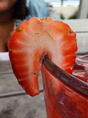 Strawberry garnish on juice.